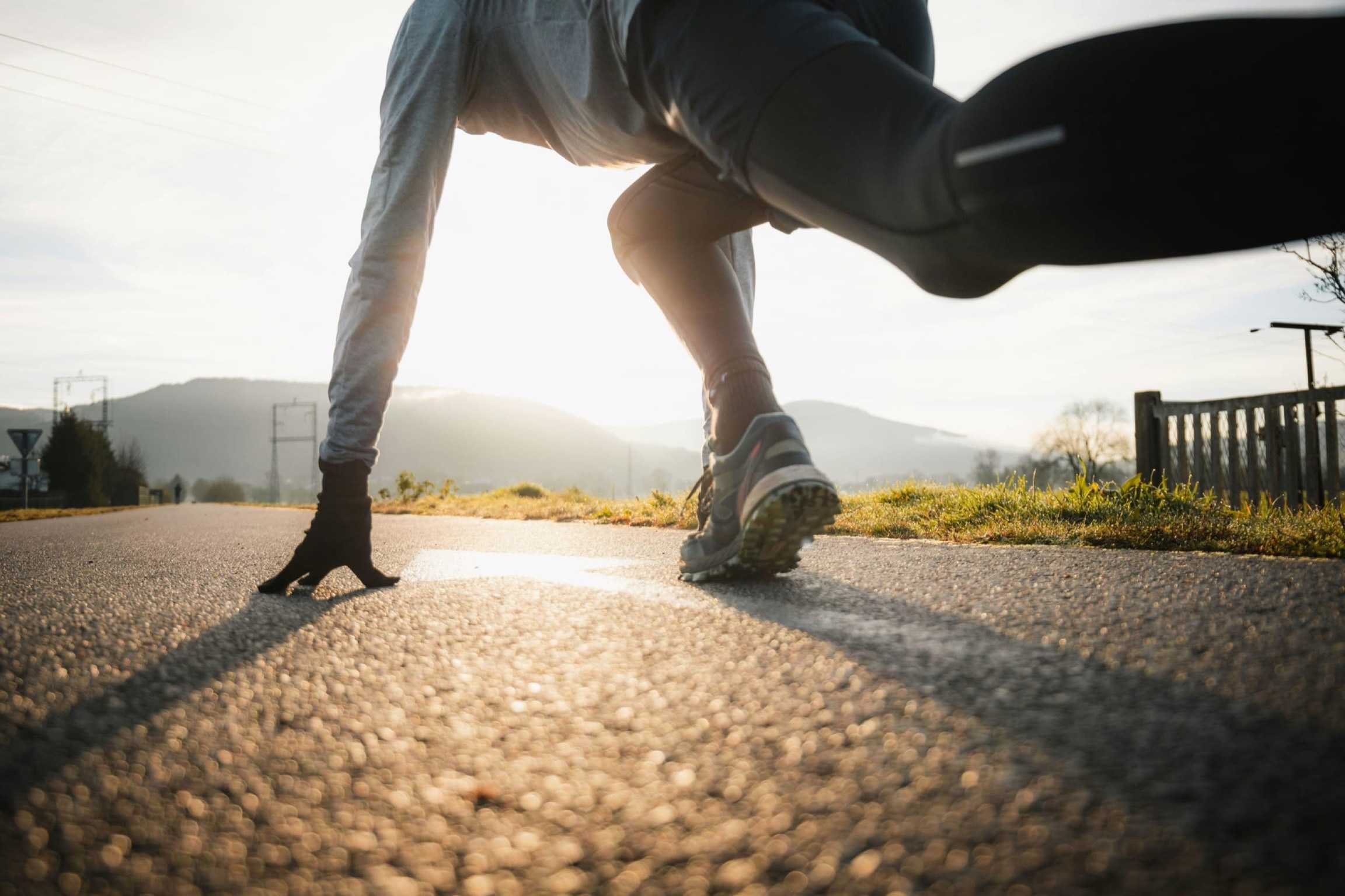 A runner climbing a trail at first light